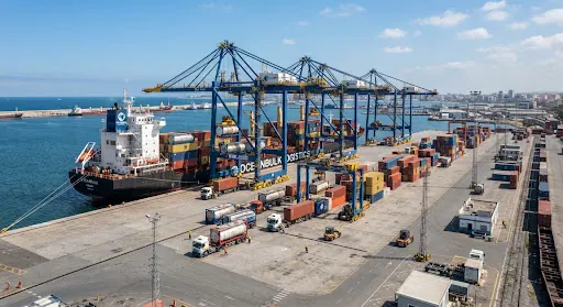 Container ship being loaded by gantry cranes at a port