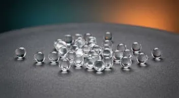 Clear polymer beads on a dark surface