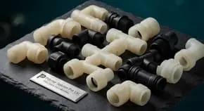 PVC pipe fittings on a dark surface